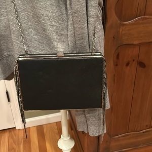 Sondra Robert’s black clutch/shoulder bag